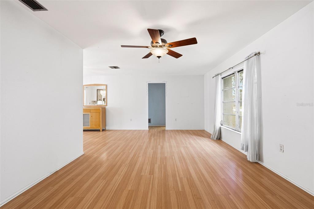 2101 Broad Ranch Drive Port Charlotte, FL 33948 - Photo 8 of 39 a view of empty room with wooden floor and fan