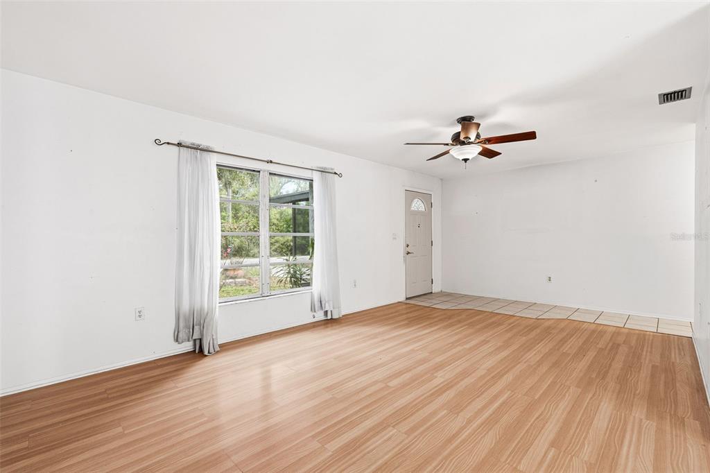 2101 Broad Ranch Drive Port Charlotte, FL 33948 - Photo 10 of 39 wooden floor in an empty room with a window