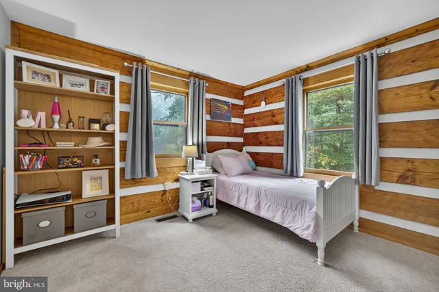 a view of deck with wooden floor and fence next to a yard