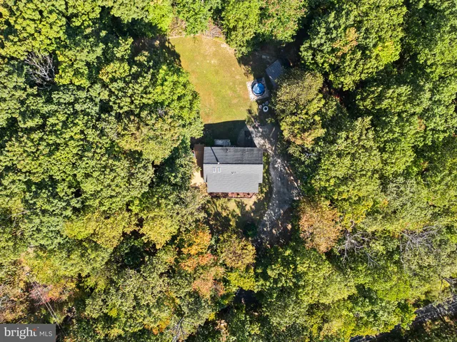 a kitchen with stainless steel appliances granite countertop wooden cabinets a stove top oven a sink and dishwasher with wooden floor