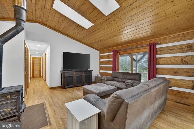 a bedroom with a bed and a flat tv screen next to a window