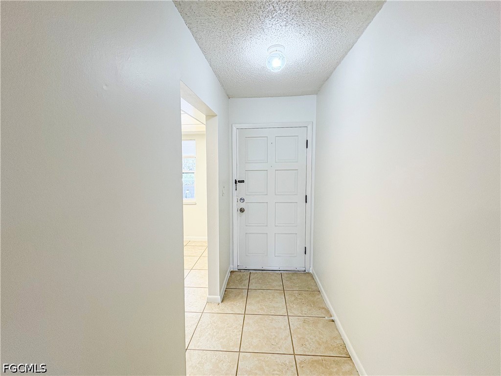 1830 Brantley Road, Unit I7 Fort Myers, FL 33907 - Photo 4 of 34 an empty room with white walls and tiles