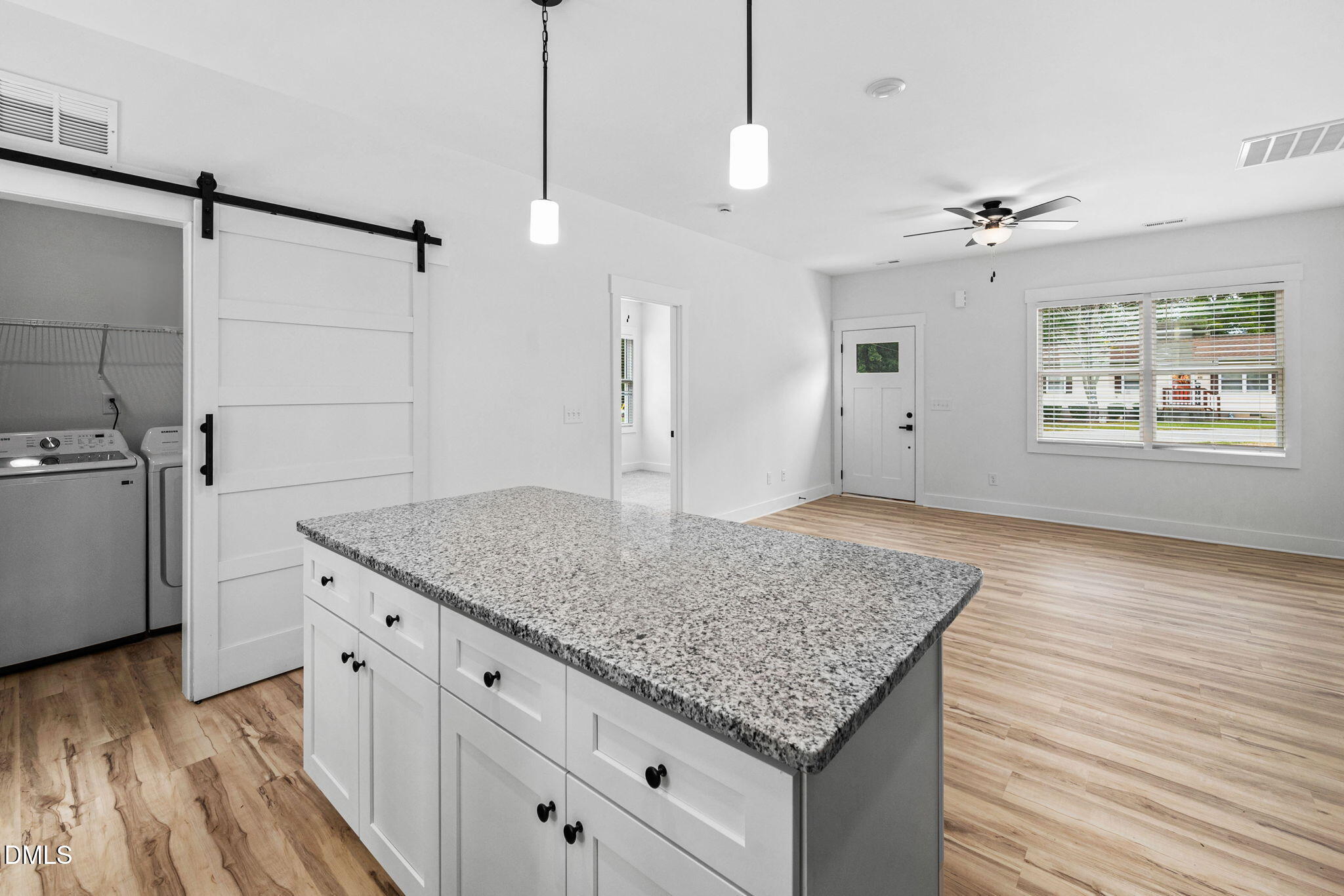 183 Magnolia Drive Roxboro, NC 27573 - Photo 16 of 31 a kitchen with kitchen island a counter space a sink appliances and a counter top space