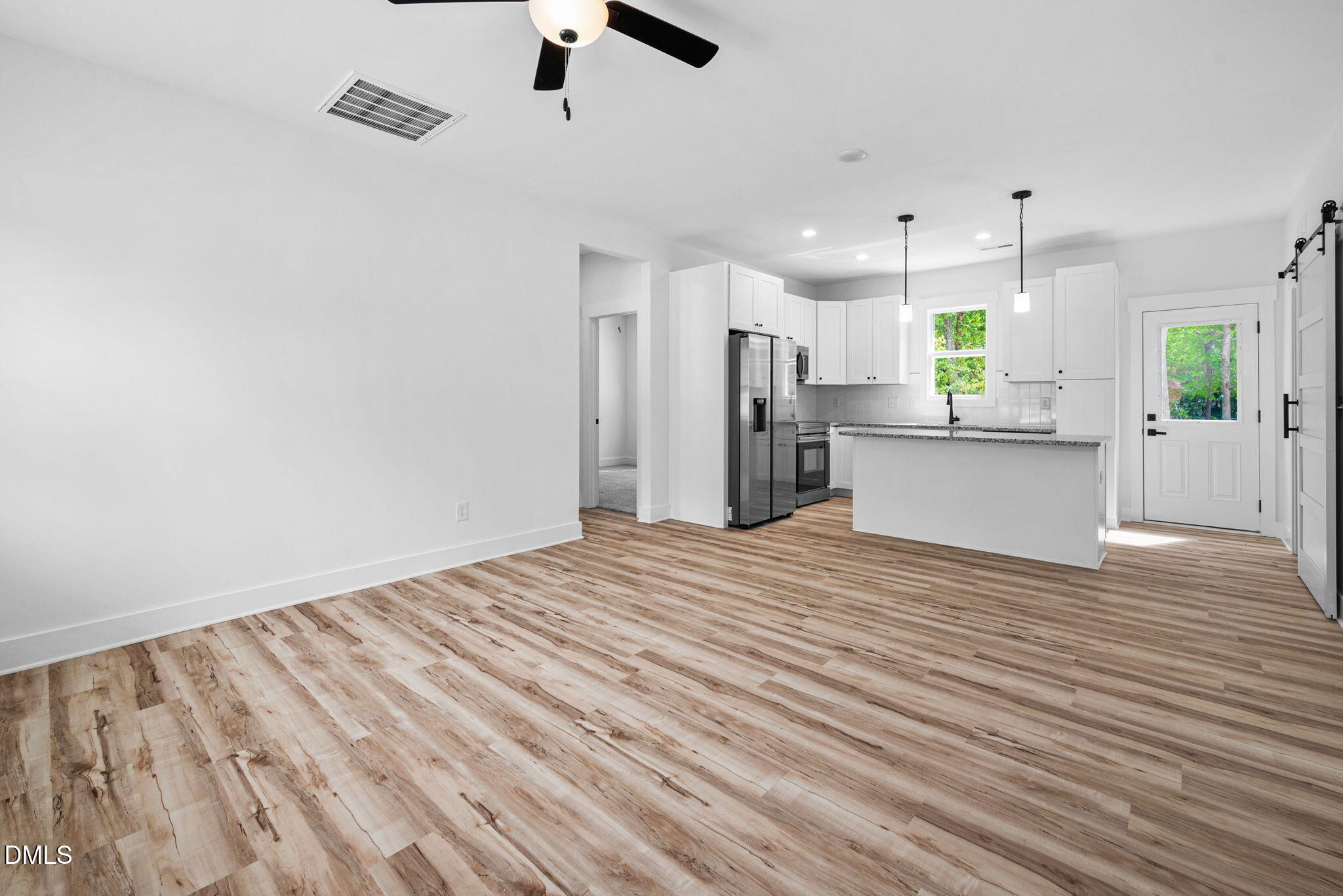 183 Magnolia Drive Roxboro, NC 27573 - Photo 18 of 31 an empty room with wooden floor and stainless steel appliances