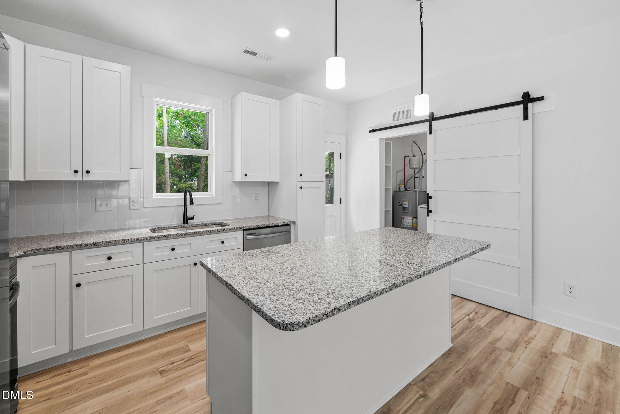 183 Magnolia Drive Roxboro, NC 27573 - Photo 19 of 31 a kitchen with stainless steel appliances granite countertop a sink a center island and cabinets
