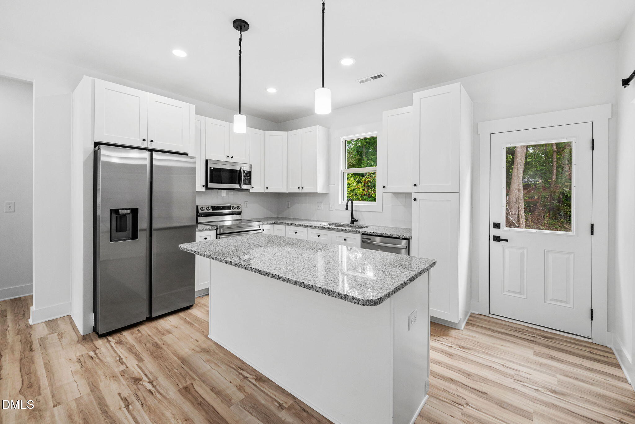 183 Magnolia Drive Roxboro, NC 27573 - Photo 20 of 31 a kitchen with kitchen island granite countertop a sink a counter top space stainless steel appliances and cabinets