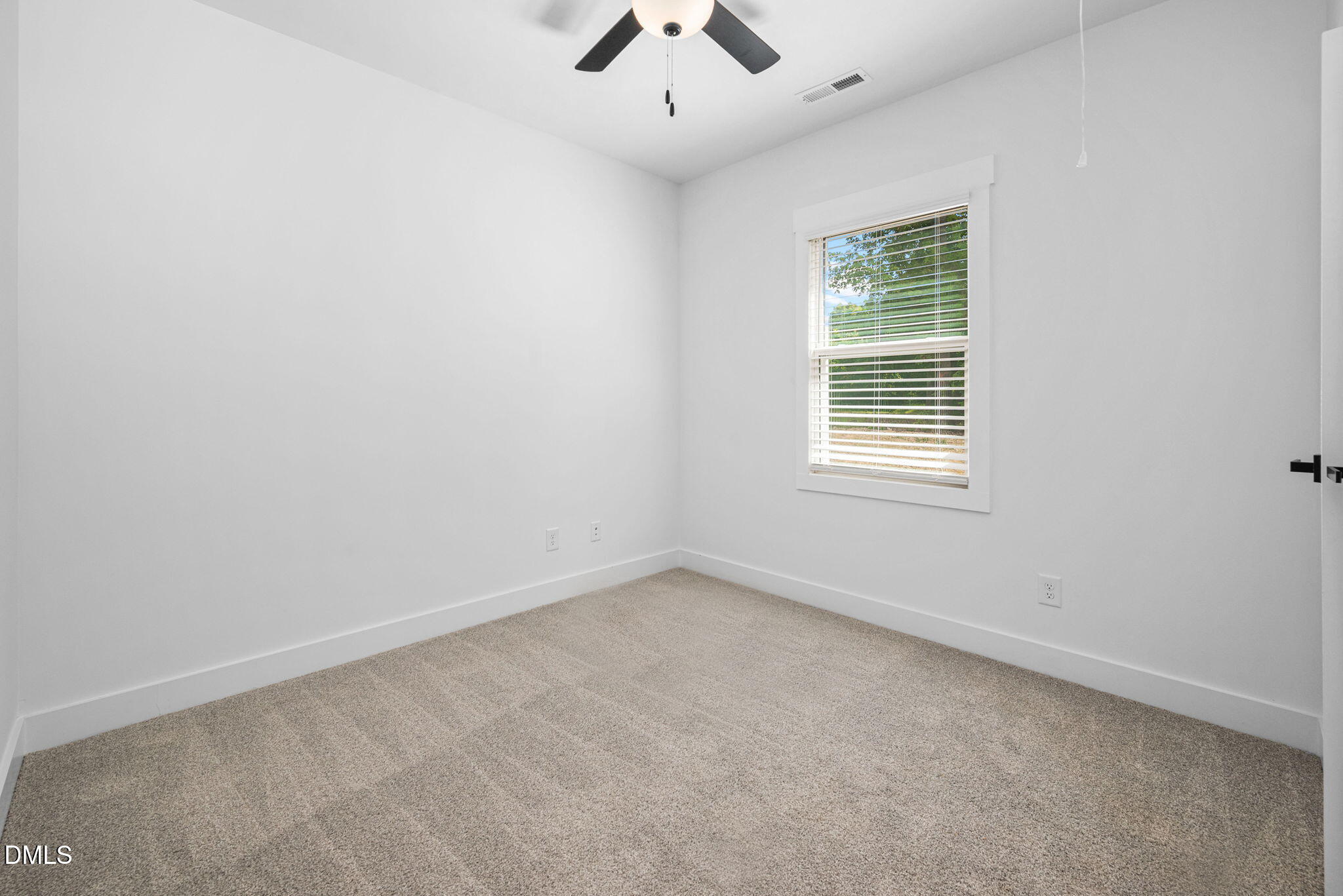 183 Magnolia Drive Roxboro, NC 27573 - Photo 28 of 31 an empty room with a window and a ceiling fan