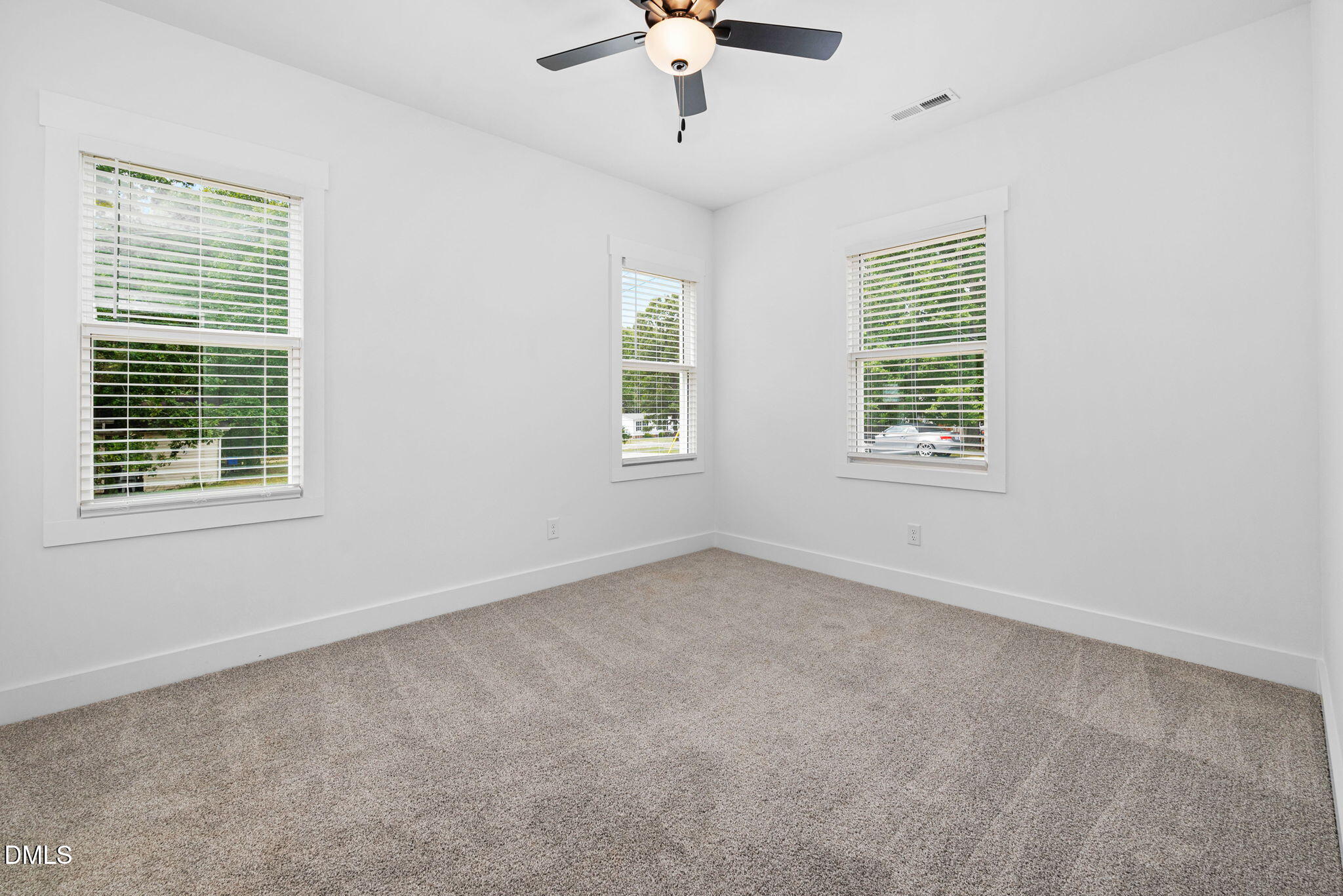 183 Magnolia Drive Roxboro, NC 27573 - Photo 31 of 31 an empty room with windows and chandelier fan
