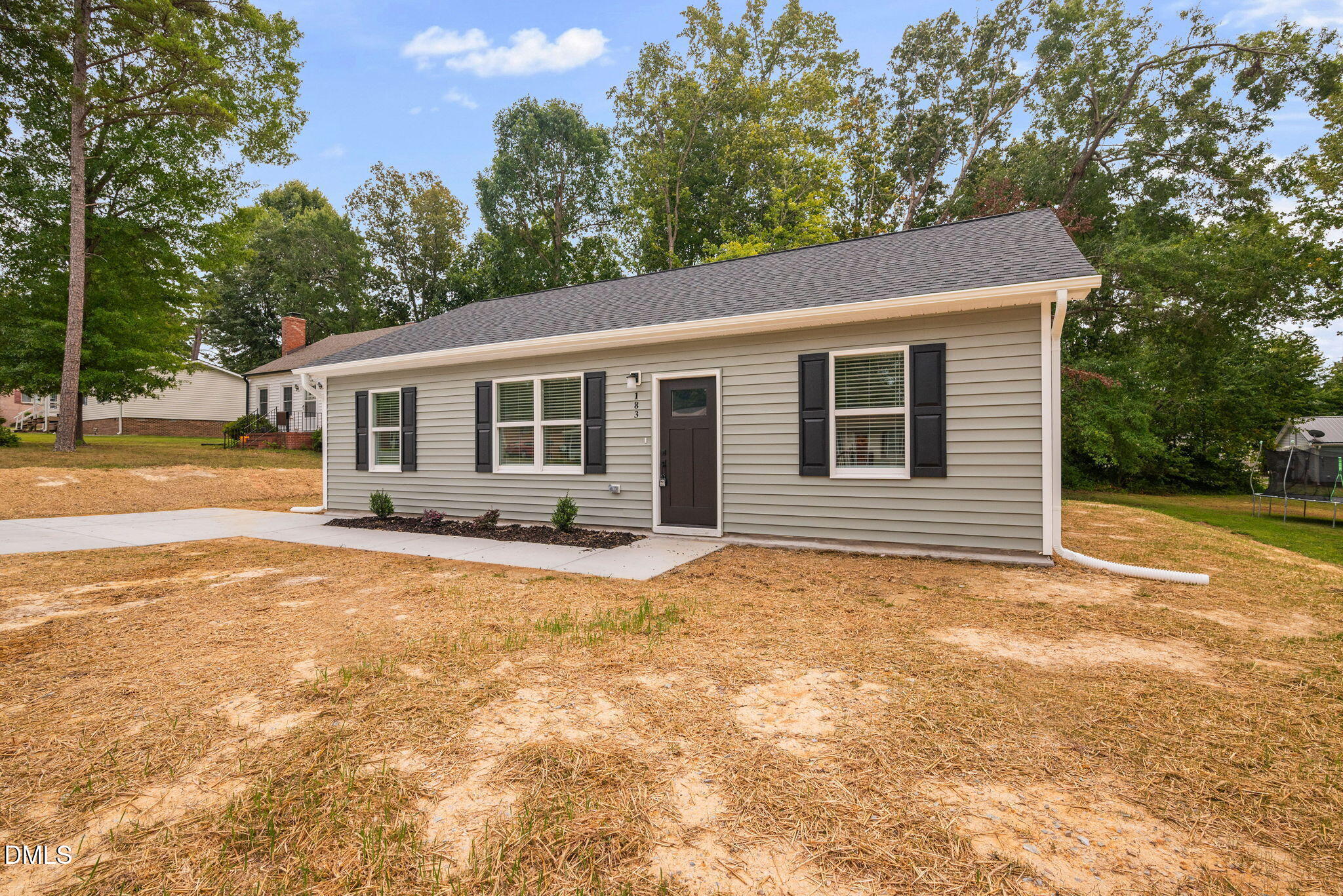 183 Magnolia Drive Roxboro, NC 27573 - Photo 6 of 31 a view of a house with backyard and trees