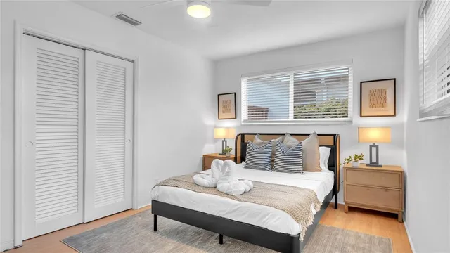 a bedroom with a large bed and a night stand