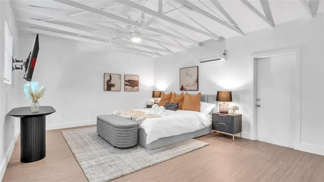 a bedroom with bed and a potted plant