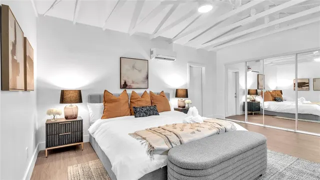 a bedroom with a bed and a view of living room