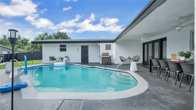a view of a swimming pool with chairs