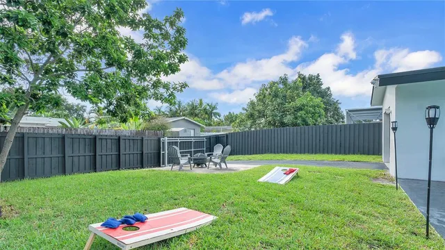 a backyard of a house with table and chairs