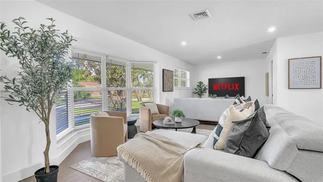 a living room with furniture and a large window