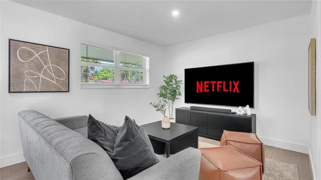 a living room with furniture workspace and a flat screen tv