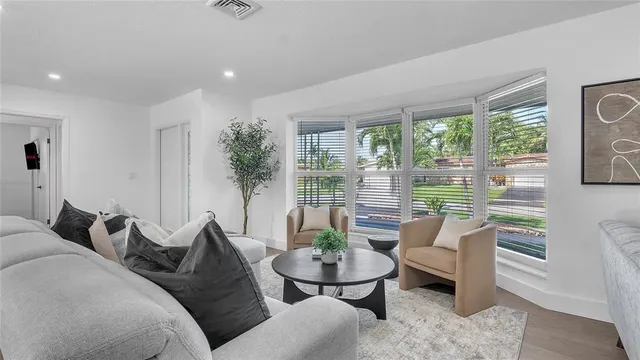 a living room with furniture and a potted plant