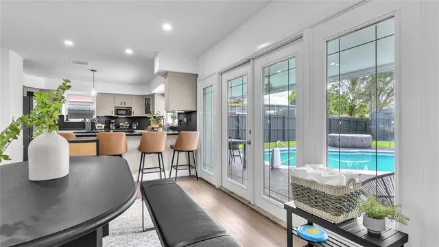 a dining room with furniture and a floor to ceiling window