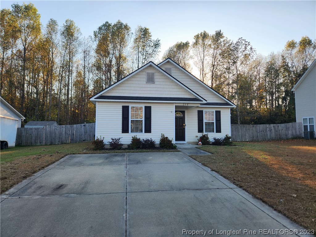 268 Cape Fear Road Raeford, NC 28376 - Photo 1 of 13 a front view of a house with a yard and trees