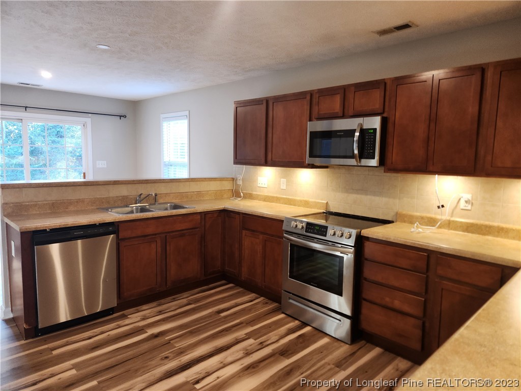 268 Cape Fear Road Raeford, NC 28376 - Photo 3 of 13 a kitchen with stainless steel appliances granite countertop a sink stove and microwave