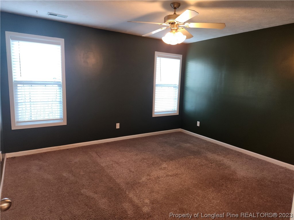 268 Cape Fear Road Raeford, NC 28376 - Photo 10 of 13 an empty room with a window and a fan
