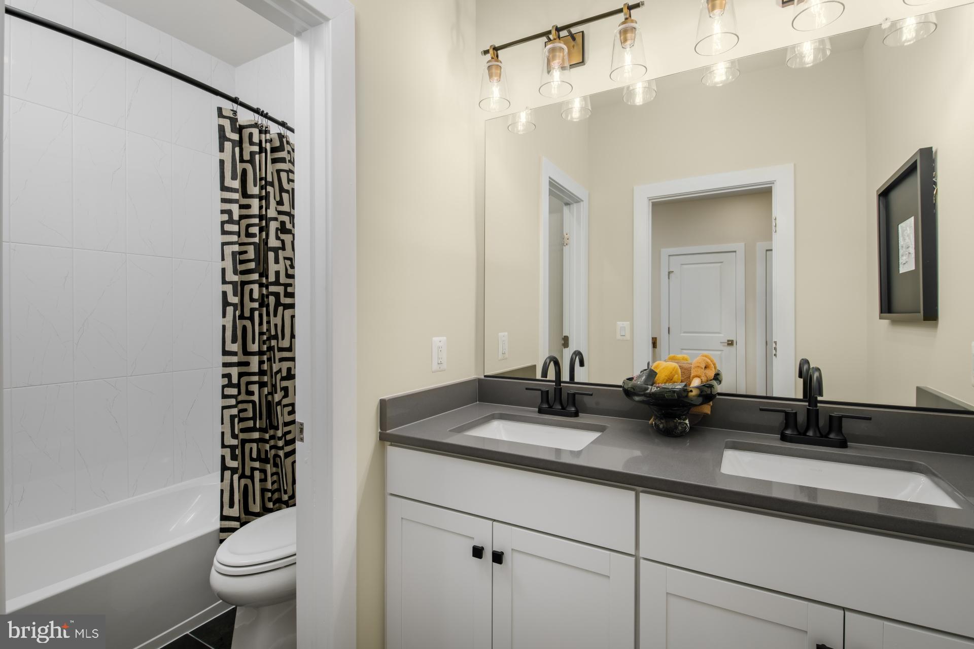 39 Strabane Terrace Ashburn, VA 20147 - Photo 11 of 15 a bathroom with a double vanity sink toilet and shower