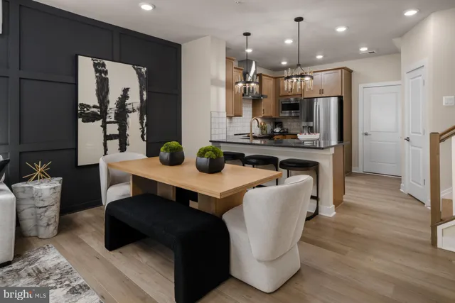 a living room with stainless steel appliances kitchen island granite countertop furniture and a view of kitchen