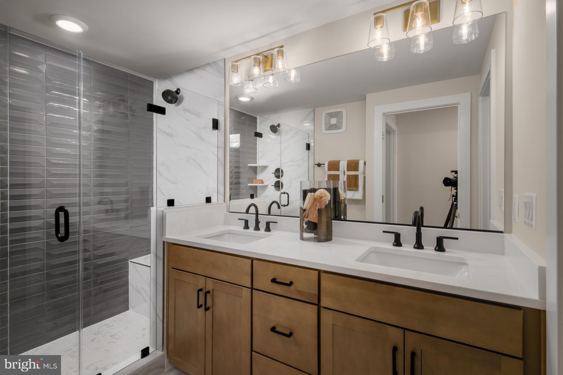 39 Strabane Terrace Ashburn, VA 20147 - Photo 8 of 15 a bathroom with double vanity sink a mirror and shower