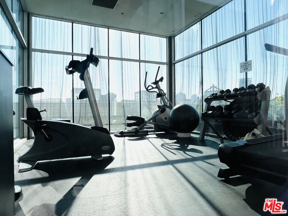 756 South Spring Street, Unit 404 Los Angeles, CA 90014 - Photo 11 of 14 a room with furniture and gym equipment