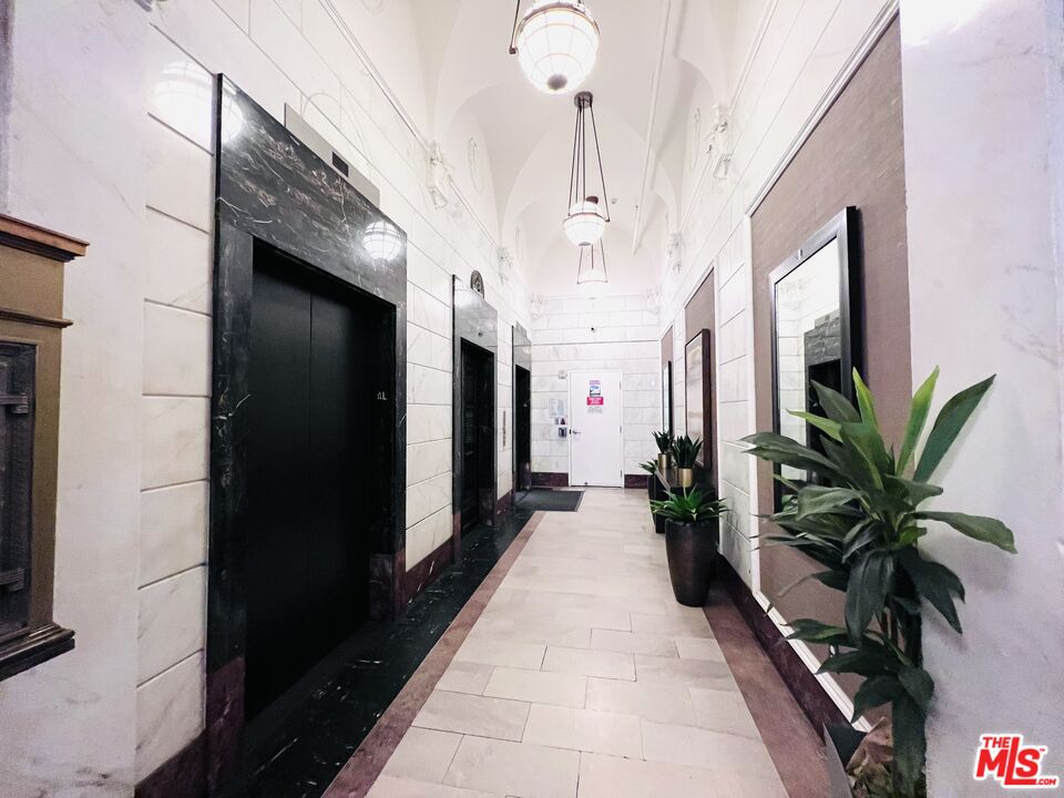 756 South Spring Street, Unit 404 Los Angeles, CA 90014 - Photo 12 of 14 a lobby with furniture and a potted plant