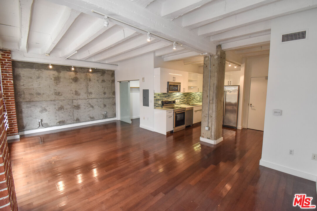756 South Spring Street, Unit 404 Los Angeles, CA 90014 - Photo 4 of 14 a view of a room with wooden floor and a window