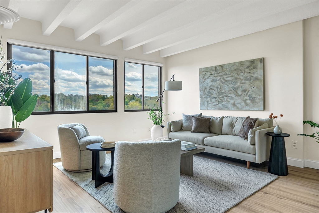 1731 Beacon Street, Unit 1515 Brookline, MA 02445 - Photo 13 of 40 a living room with furniture and a large window