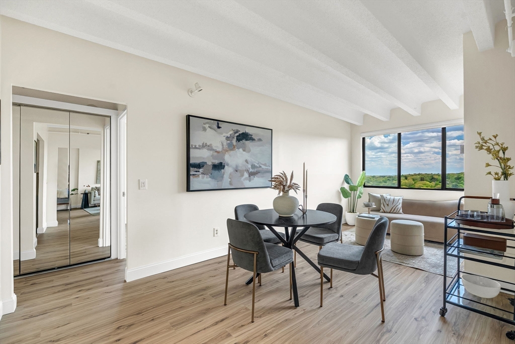 1731 Beacon Street, Unit 1515 Brookline, MA 02445 - Photo 15 of 40 a dining room with furniture and wooden floor