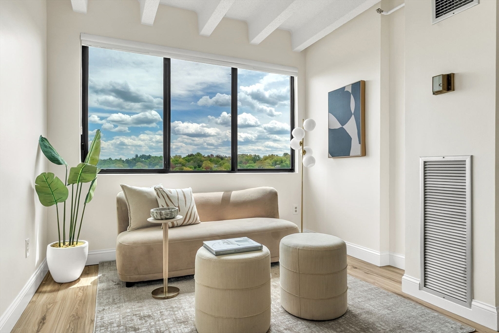 1731 Beacon Street, Unit 1515 Brookline, MA 02445 - Photo 17 of 40 a living room with furniture and floor to ceiling windows