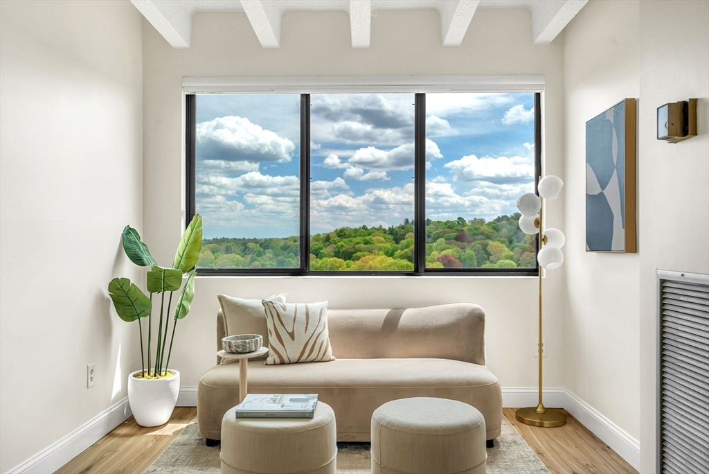1731 Beacon Street, Unit 1515 Brookline, MA 02445 - Photo 18 of 40 a living room with furniture and a floor to ceiling window