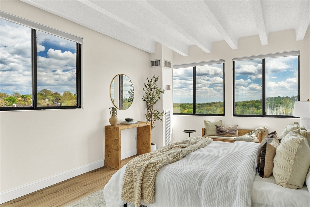 1731 Beacon Street, Unit 1515 Brookline, MA 02445 - Photo 22 of 40 a bedroom with bed and a large window with outer view