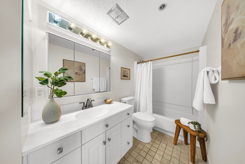 1731 Beacon Street, Unit 1515 Brookline, MA 02445 - Photo 27 of 40 a bathroom with a sink a toilet and shower