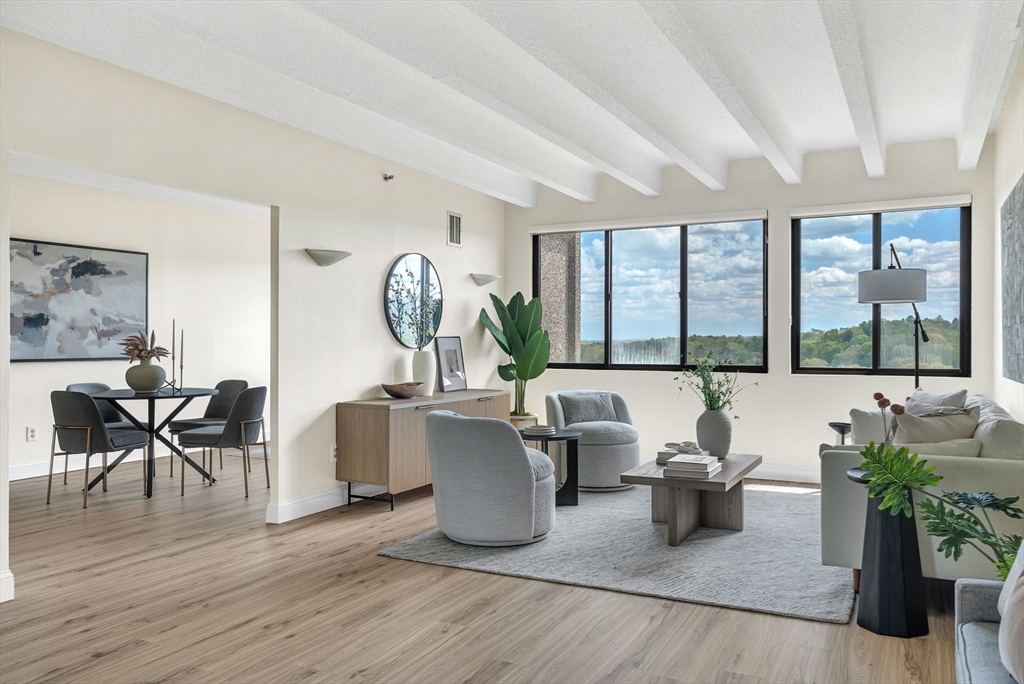 1731 Beacon Street, Unit 1515 Brookline, MA 02445 - Photo 6 of 40 a living room with furniture and a large window