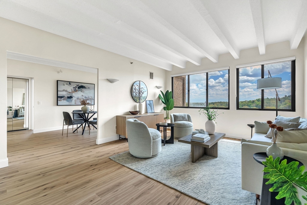 1731 Beacon Street, Unit 1515 Brookline, MA 02445 - Photo 8 of 40 a living room with furniture and a large window
