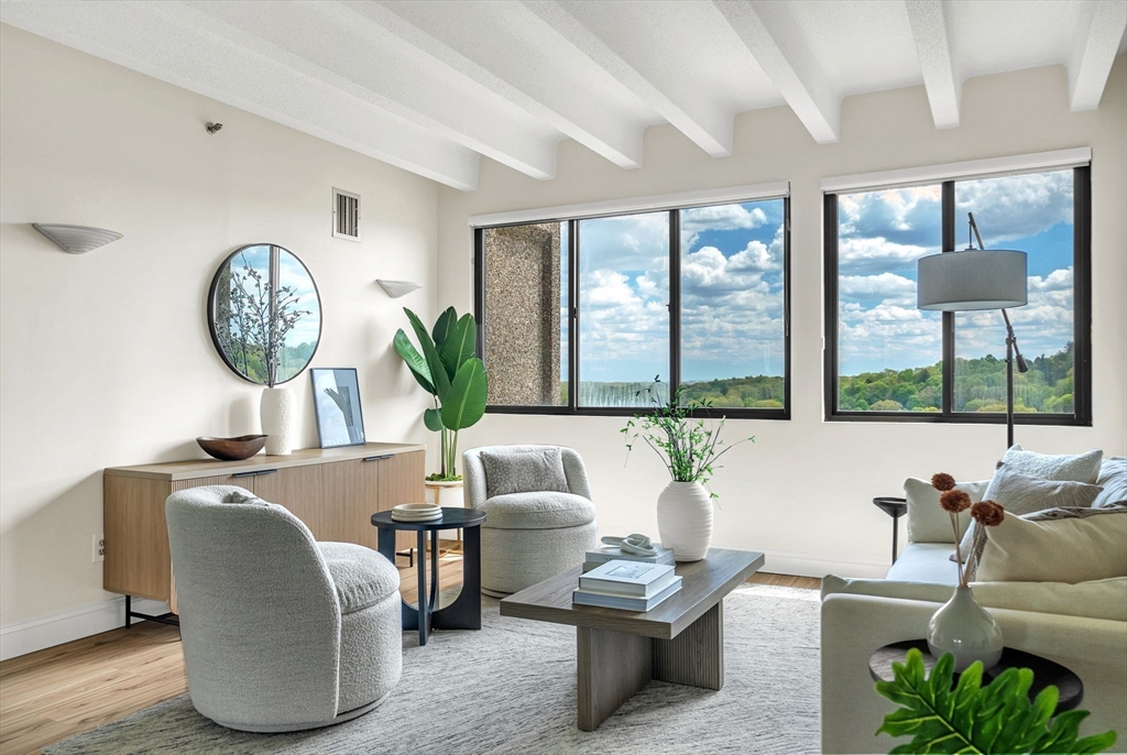 1731 Beacon Street, Unit 1515 Brookline, MA 02445 - Photo 9 of 40 a living room with furniture and a large window