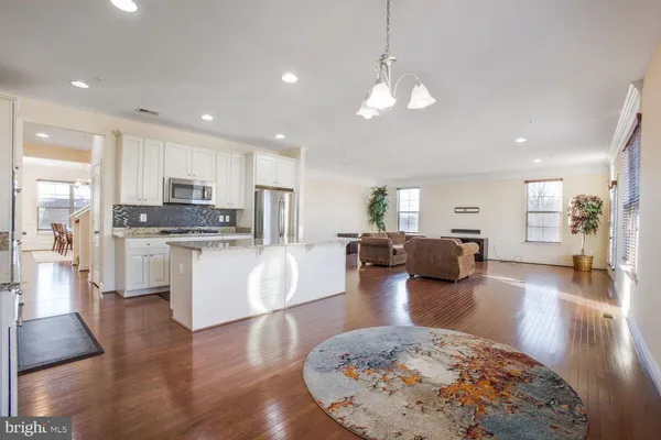 a living room with fireplace furniture and a wooden floor