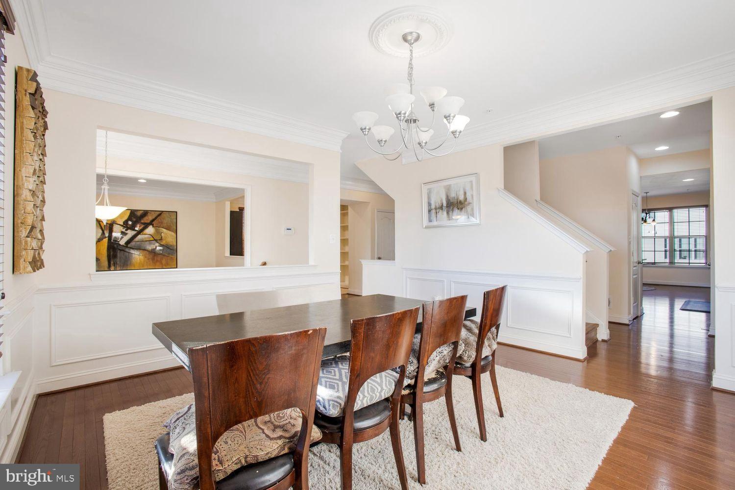 3041 Bel Pre Road Silver Spring, MD 20906 - Photo 10 of 30 a view of a dining room with furniture wooden floor and chandelier