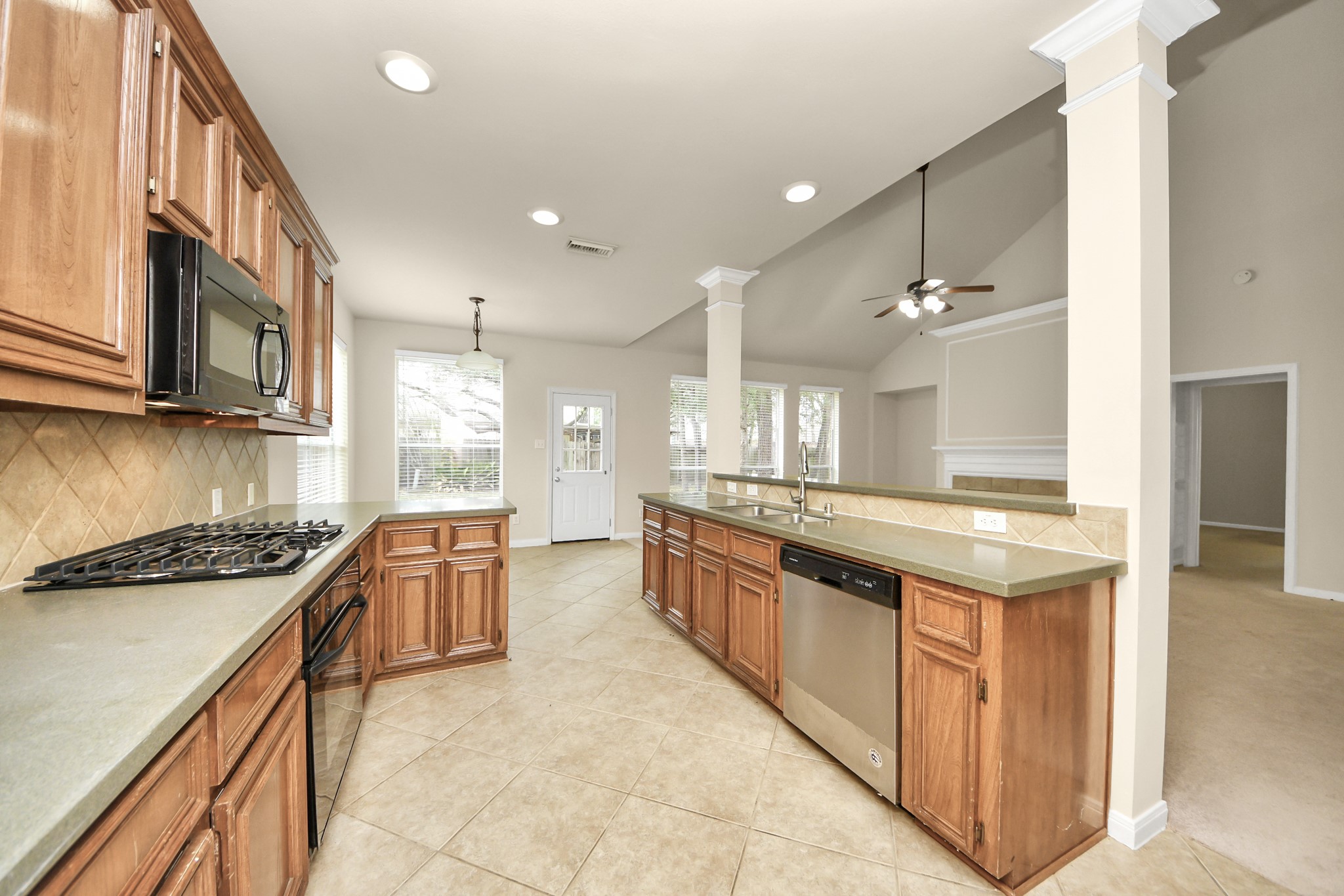 28306 Peper Hollow Lane Spring, TX 77386 - Photo 17 of 39 a large kitchen with stainless steel appliances granite countertop a stove and a sink