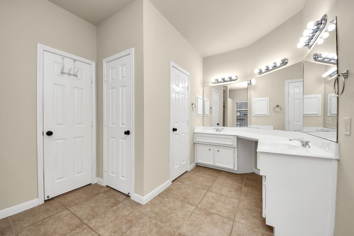 28306 Peper Hollow Lane Spring, TX 77386 - Photo 24 of 39 a large bathroom with a granite countertop double vanity sink a mirror and a bathtub