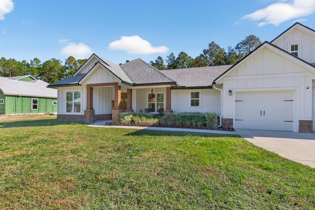75774 Edwards Road Yulee, FL 32097 - Photo 8 of 70 a front view of a house with a yard and porch