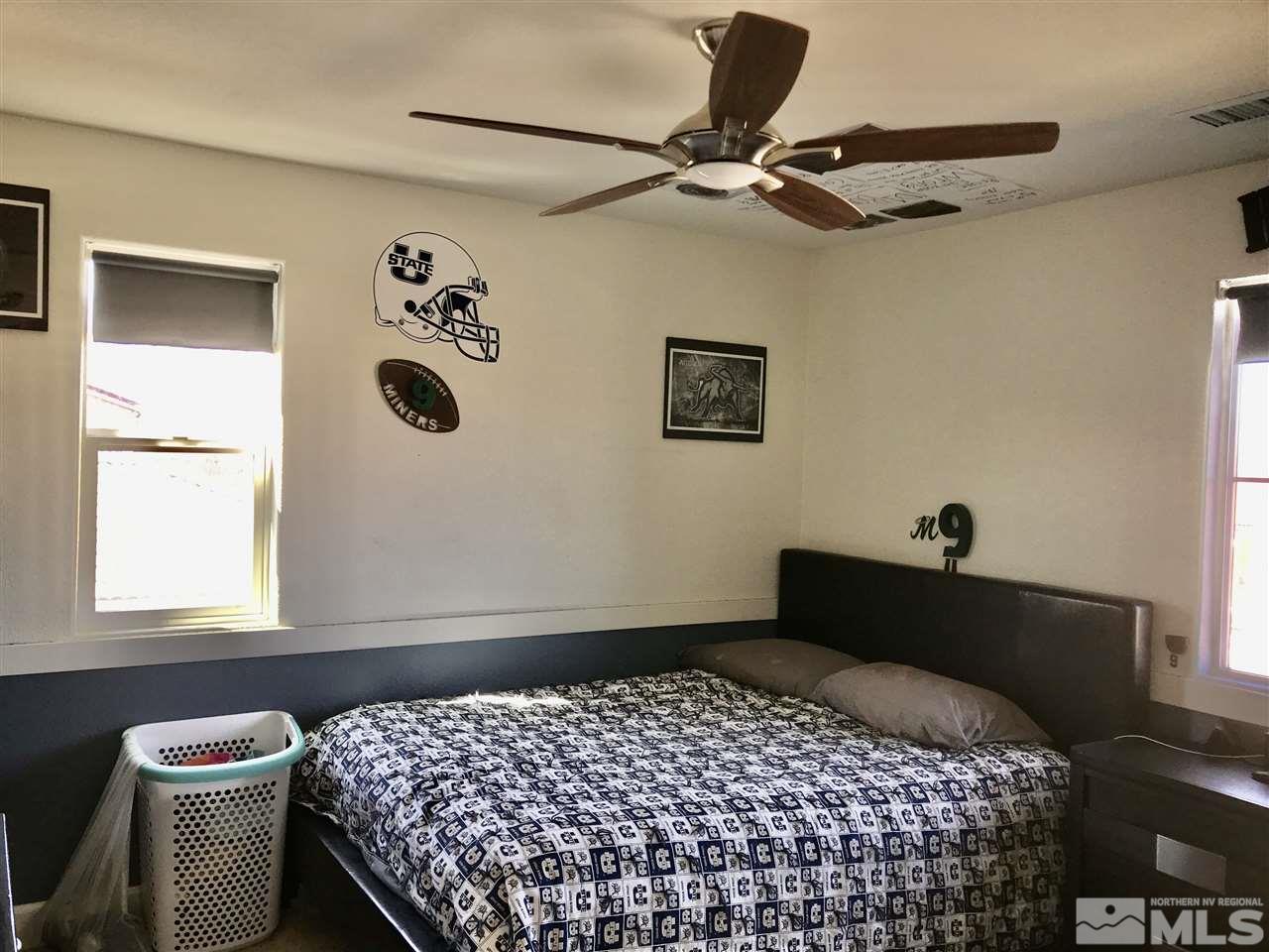 11610 Cervino Drive Reno, NV 89521 - Photo 11 of 20 a bedroom with a bed and a window