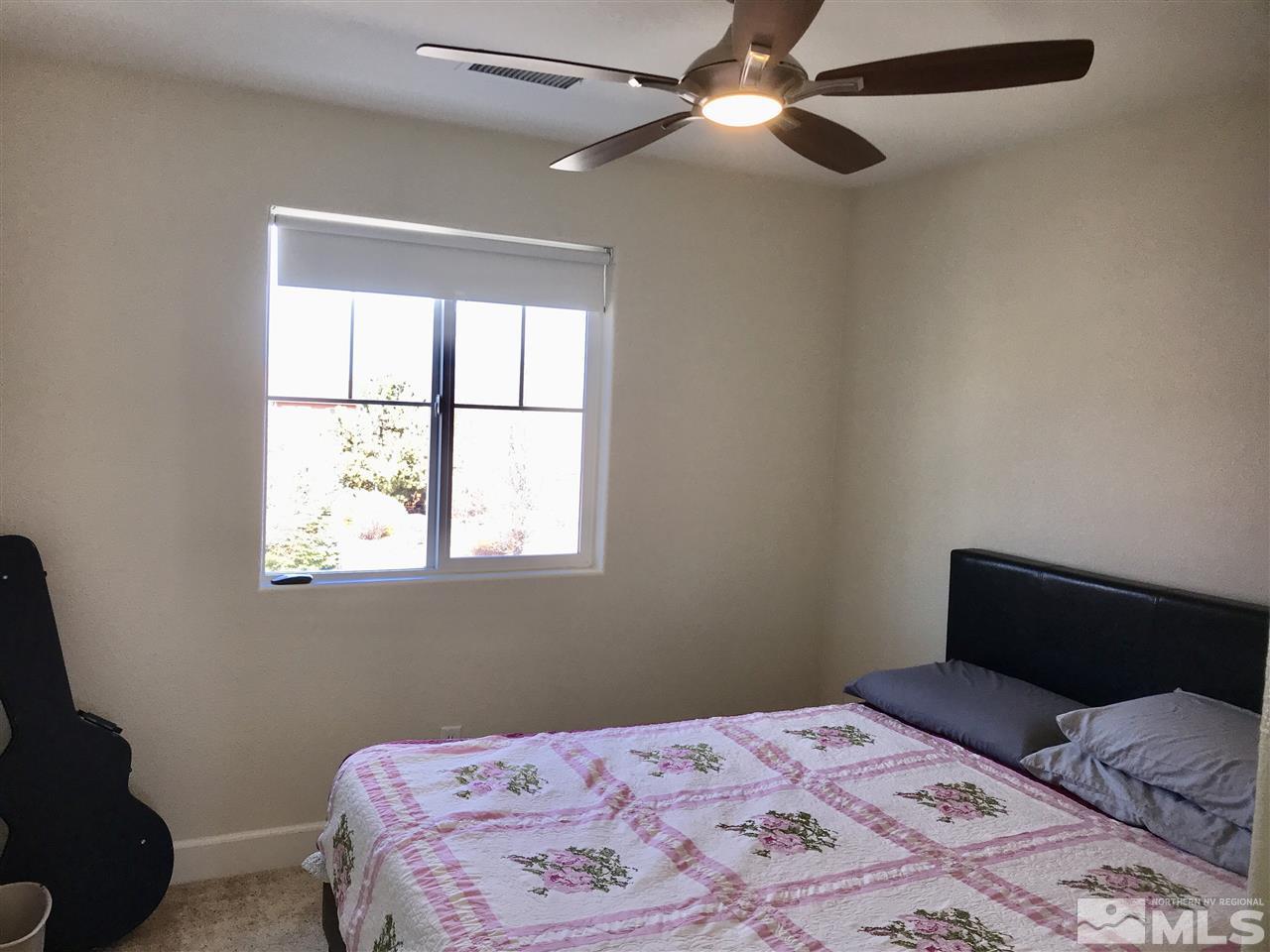 11610 Cervino Drive Reno, NV 89521 - Photo 13 of 20 a bedroom with a bed and a window