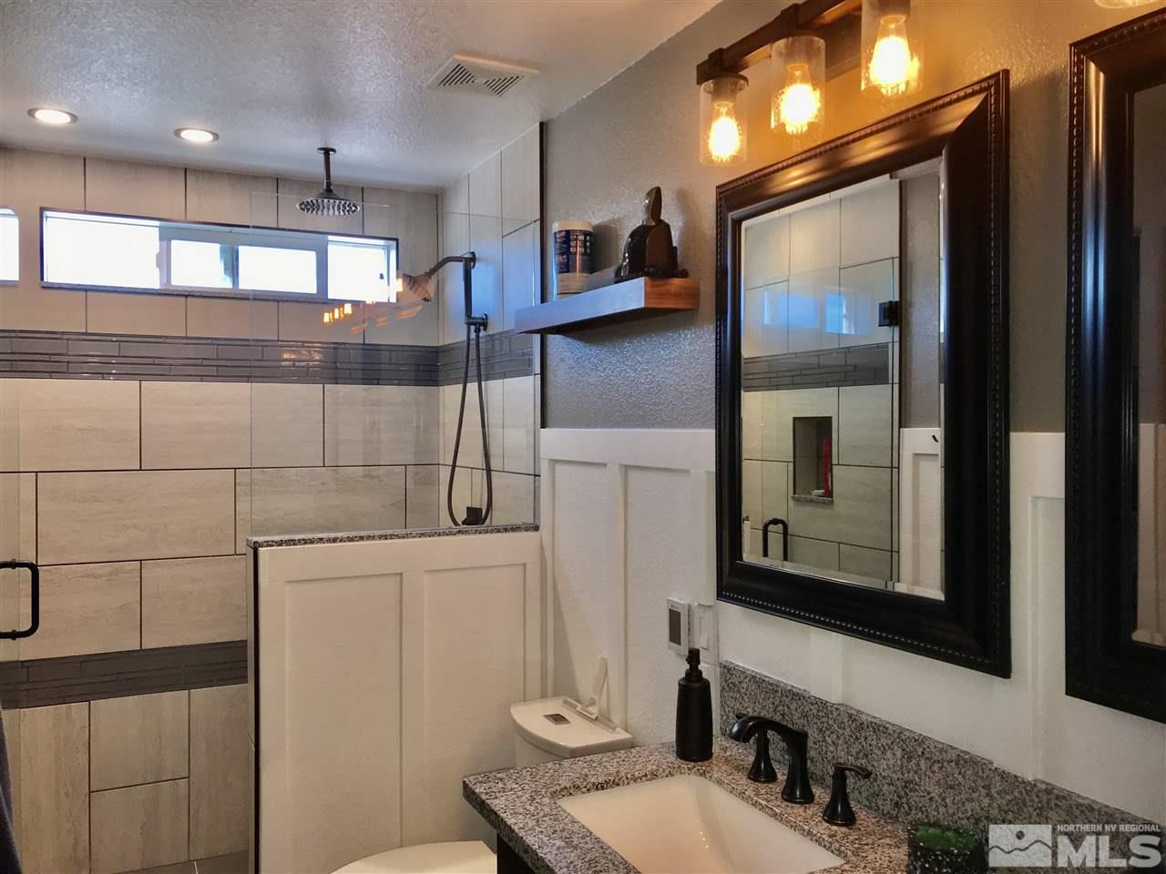 11610 Cervino Drive Reno, NV 89521 - Photo 15 of 20 a bathroom with a sink a toilet and mirror