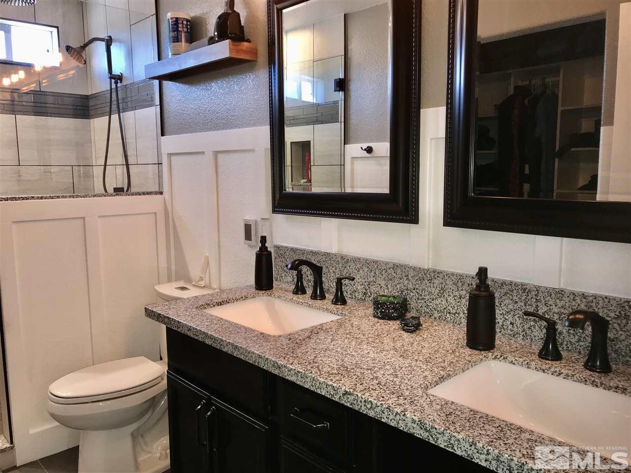 11610 Cervino Drive Reno, NV 89521 - Photo 10 of 20 a bathroom with a granite countertop sink a toilet and mirror