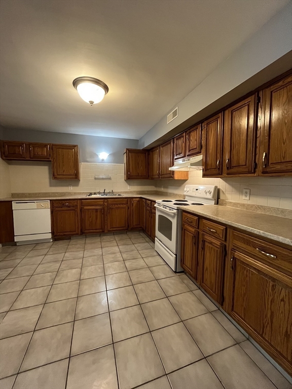 120 15th Street, Unit 4 Fall River, MA 02723 - Photo 2 of 8 a kitchen with stainless steel appliances granite countertop a sink and cabinets